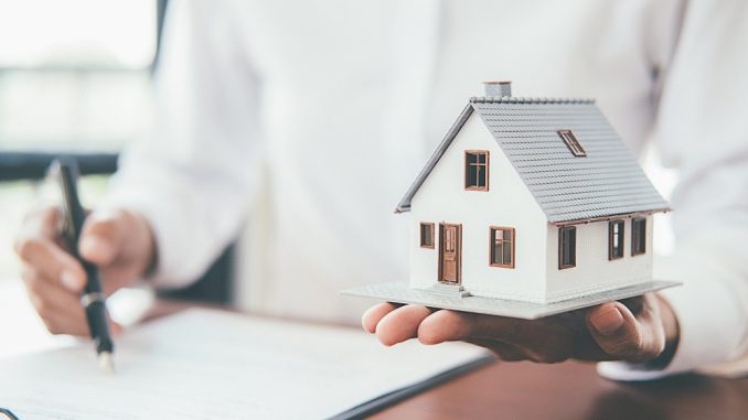 House model with real estate agent and customer discussing for contract to buy house, insurance or loan real estate background.